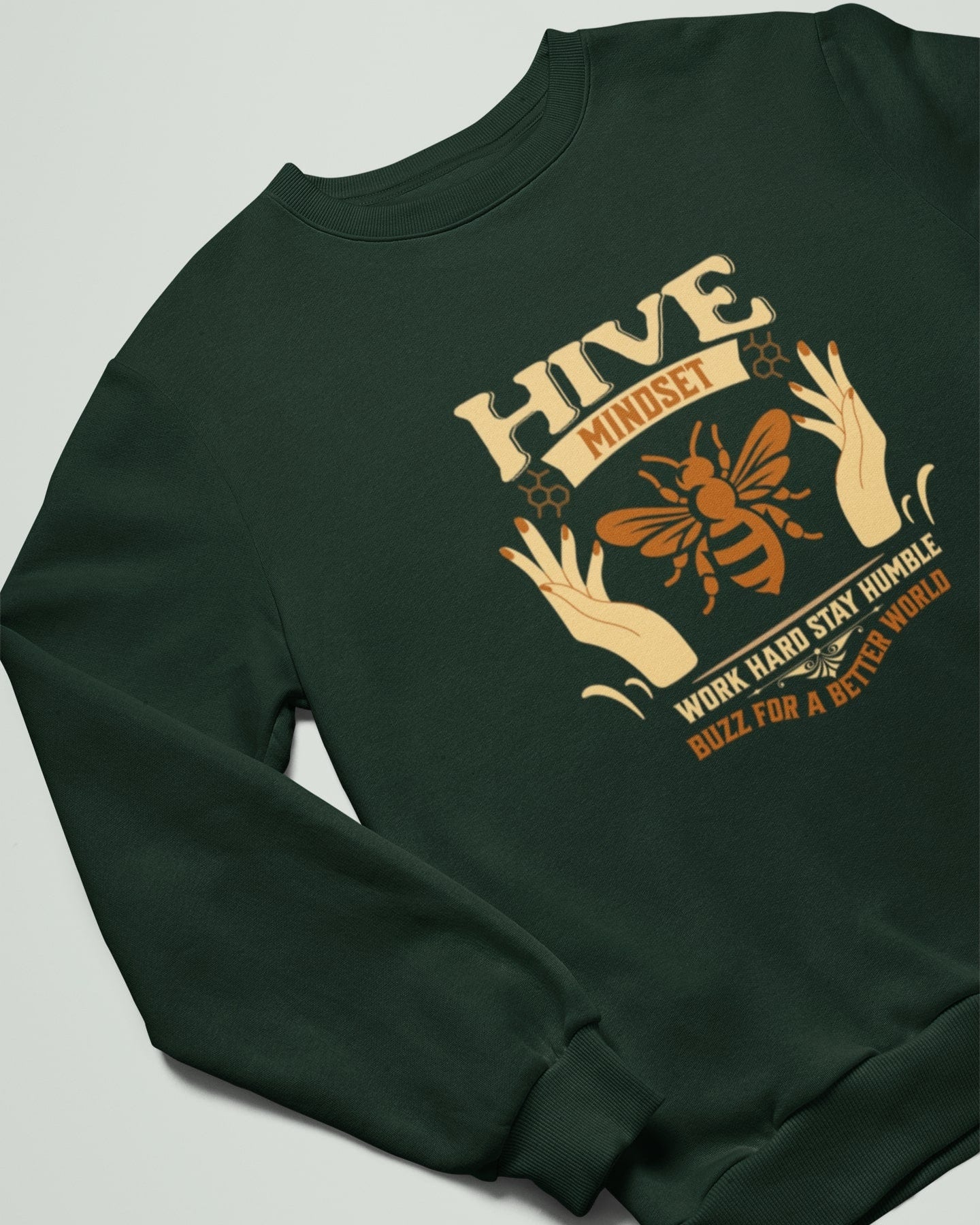 Green sweatshirt with a bee and text design on a light gray background